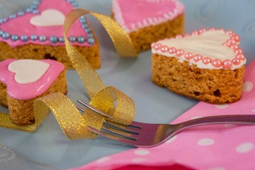 Heart shape gingerbread cookies, napkin and fork kept on plate