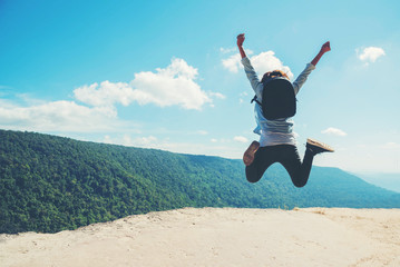 young woman Jumping  at mountain view  for sun light