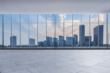 Fototapeta premium The modern office buildings from glass window