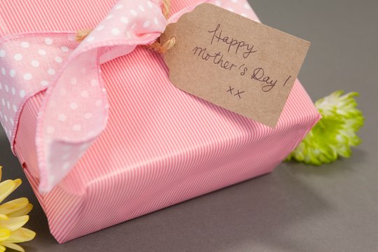 Gift box with happy mothers day card and flowers