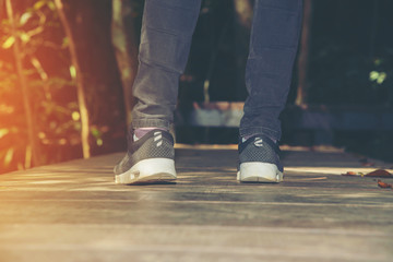 Fototapeta premium woman trekking in forest and sun light