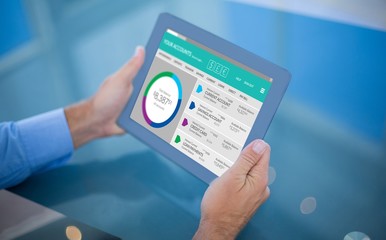 Composite image of businessman using his tablet 