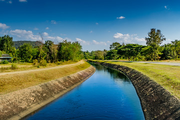 Fototapeta na wymiar Irrigation canal with blue sky