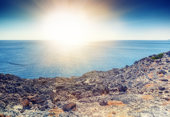 Beautiful sea landscape, pebble coast with sunset sky
