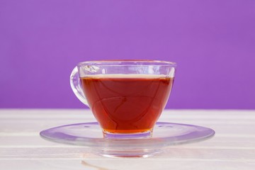 Cup of herbal tea on white table