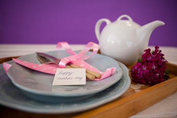 Happy mothers day card with teapot on wooden tray