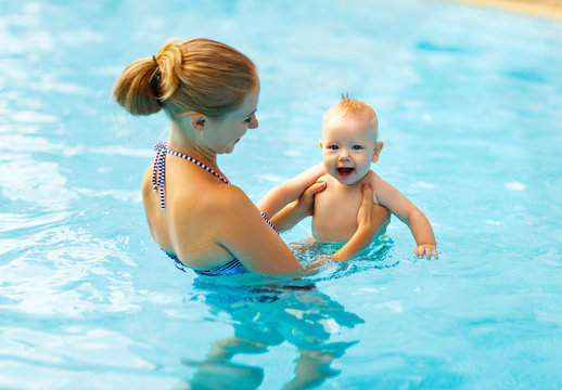 Mother and baby swim  in pool