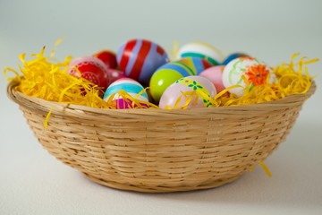 Fototapeta na wymiar Painted easter eggs in basket