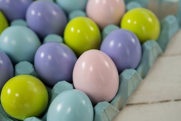 Multicolored Easter eggs in the carton