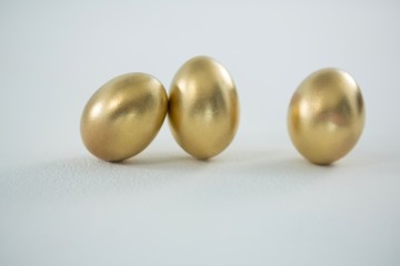 Golden Easter eggs on white background