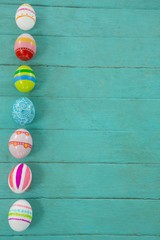 Painted Easter eggs on wooden plank