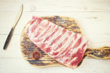raw pork ribs on a cutting board