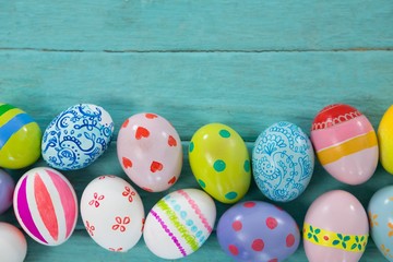 Painted Easter eggs on wooden plank