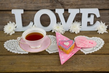 Cookies, tea, flowers and happy mothers day card with love text