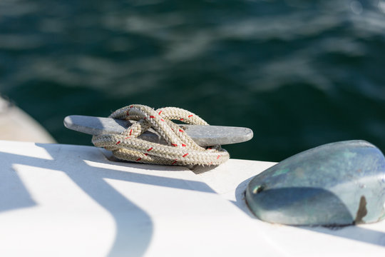 Cleat with line on the sailboat. Knot. Boat detailas