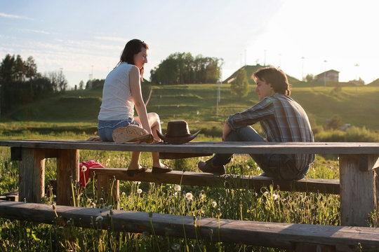 A Couple Of Young People Admire The Sunset In The Spring Evening