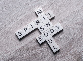Spirit soul mind and body words made of wooden cubes