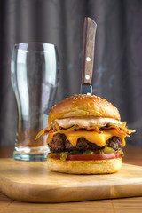 Homemade gourmet beef burger with empty glass and steak knife - 141450951