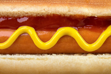 Closeup of hot dog with ketchup and yellow mustard - 141450958