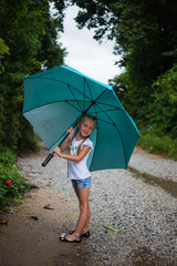 little girl with  big umbrella outdoor