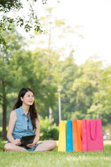 asian woman using digital tablet thinking shopping online