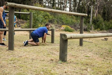 Man passing through hurdles during obstacle course