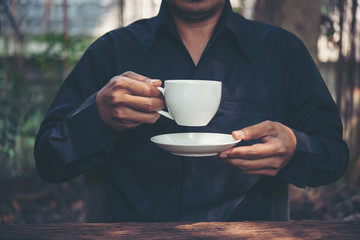 Businessman portrait drinking a coffee outdoors, Coffee break time.