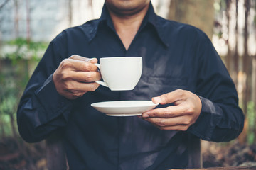 Businessman portrait drinking a coffee outdoors, Coffee break time.