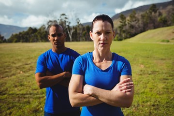 Couple standing with arms crossed during boot camp training