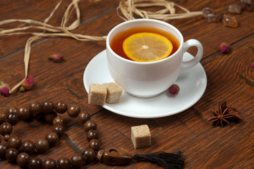 Cup of tea with lemon on a wooden table