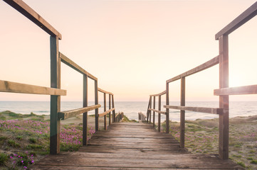 Boardwalk on a beach at sunset