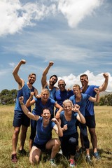 Group of fit people posing together in boot camp