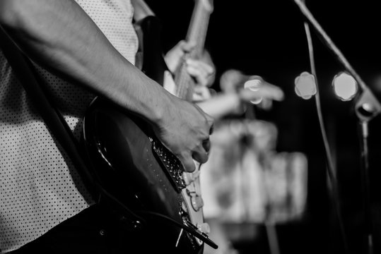 Men Playing  Guitar on stage, selective focus Black and white color.