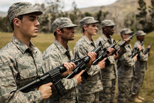 Group of military soldiers standing with rifles