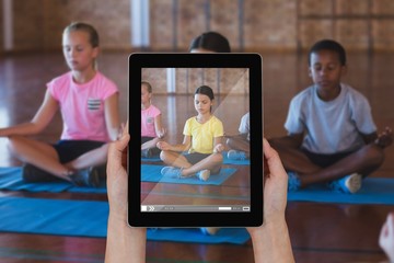 Composite image of close-up of hands holding digital tablet