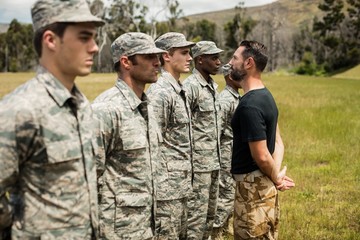 Trainer giving training to military soldier
