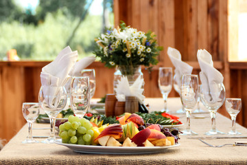 very nicely decorated wedding table with plates and serviettes.