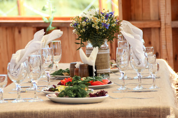very nicely decorated wedding table with plates and serviettes.