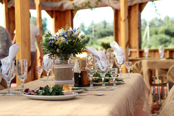 very nicely decorated wedding table with plates and serviettes.