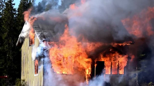 Burning home. House completely engulfed in flames 