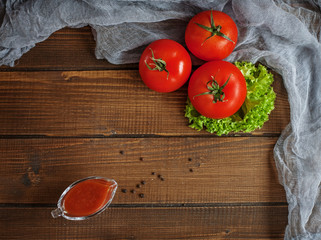 Tomatoes, lettuce, sauce and seasoning. Top view. The concept of healthy eating and vegetarianism.