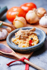 Canned stewed meat, vegetables, vintage plate and wooden spoon
