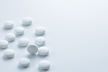 Medical,pharmacy theme background concept.White pills on white background.