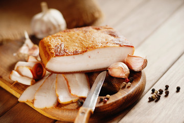 Smoked bacon, knife and sliced bread