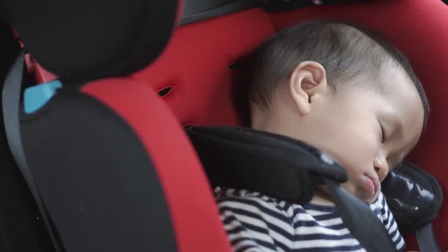 One year Asian baby sleeping in baby car seat