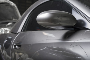 Auto body repair series : Closeup of damaged grey sport car with scratches