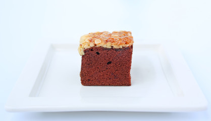 chocolate brownies on white square plate, Brownie cake topped with nuts