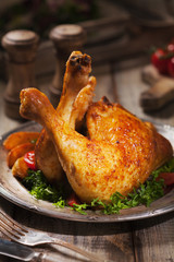Baked chicken leg, served with roasted potatoes and vegetables.