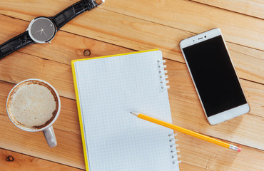 clock, camera and notebook on a brown background