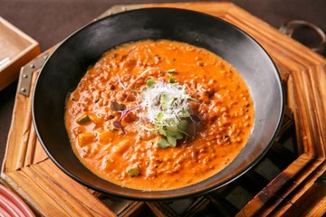 tomato risotto with wooden table